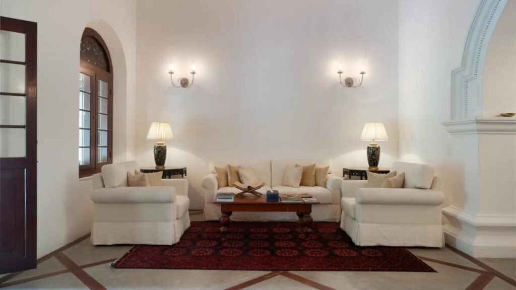 Elegant lounge interior at Adigar’s Manor in Kandy with classic white furnishings and heritage details.