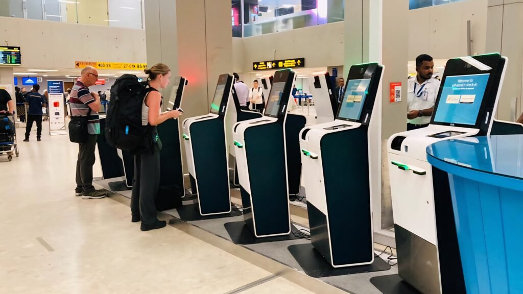 Travellers using self-service check-in kiosks at Bandaranaike International Airport.
