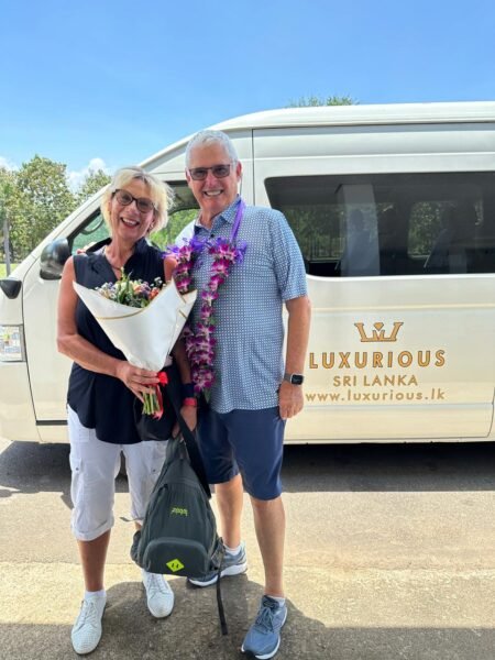 Our clients warmly welcomed beside a Luxurious Lanka vehicle.