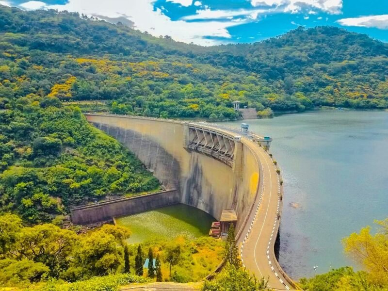 Victoria Dam and reservoir surrounded by forested hills near Digana, Sri Lanka.