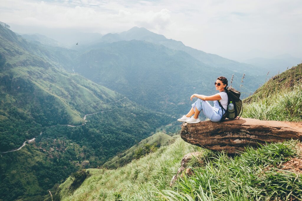 Hiker enjoying panoramic mountain views from Little Adam’s Peak in Ella, Sri Lanka.Scenic views from Little Adam’s Peak.