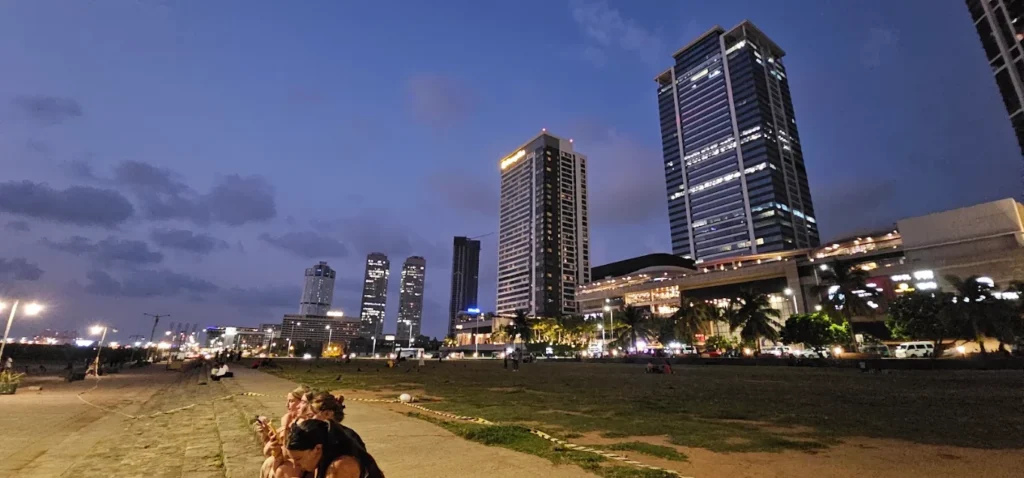 Galle Face Green at dusk with Colombo’s illuminated skyline.