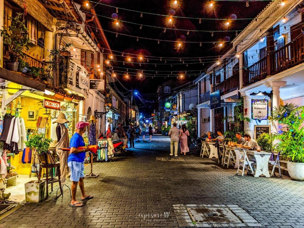 Lively evening street with shops and restaurants inside Galle Fort, Sri Lanka.