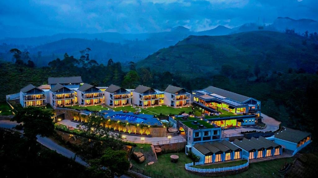 Night view of The Argyle resort surrounded by misty hills in Hatton, Sri Lanka.