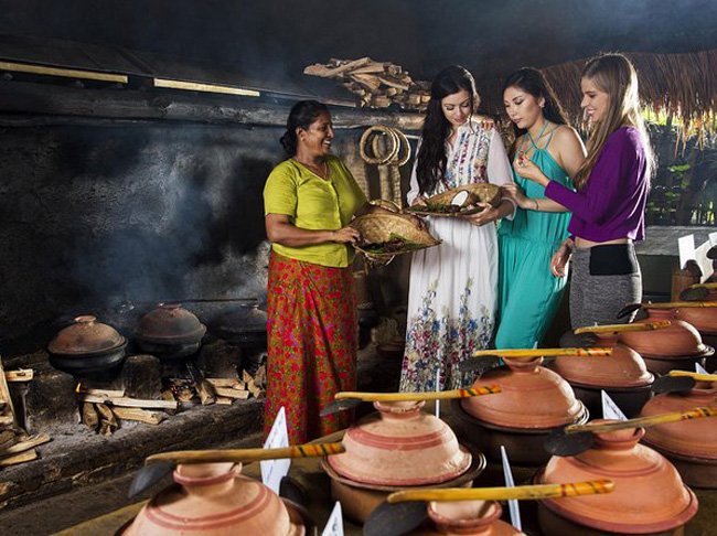 Tourists learning traditional Sri Lankan cooking in Hiriwaduna Village.