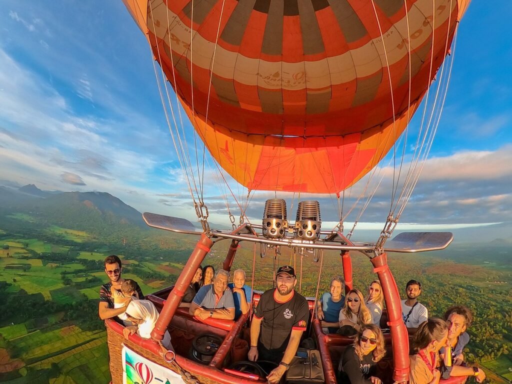 Travellers enjoying a sunrise hot-air balloon ride over Dambulla, Sri Lanka.