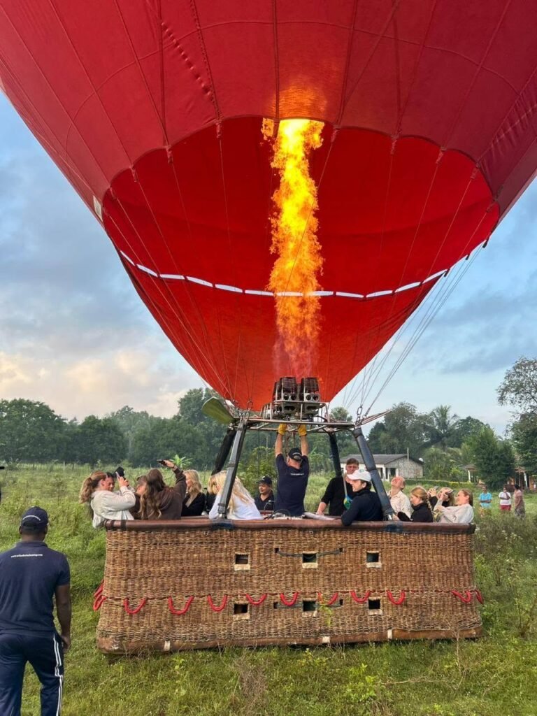 Travellers enjoying a sunrise hot-air balloon ride over Dambulla, Sri Lanka.