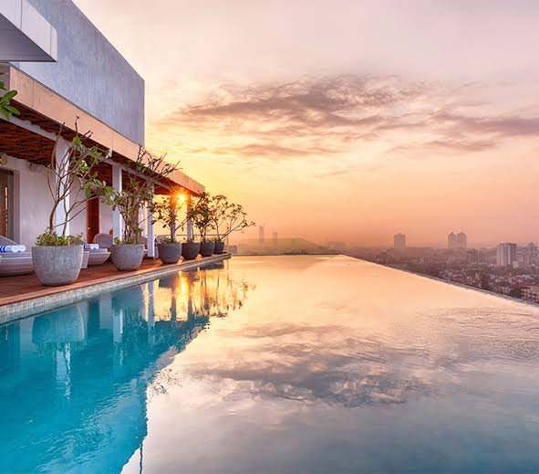 Rooftop infinity pool overlooking Colombo at sunset.