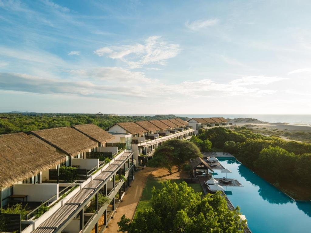 Aerial view of Jetwing Yala with rooms, swimming pool and the nearby coastline.