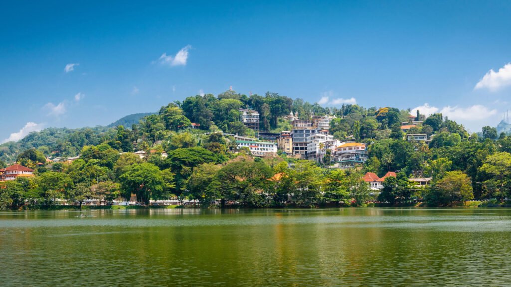 Panoramic view of Kandy city and Kandy Lake surrounded by lush hills.