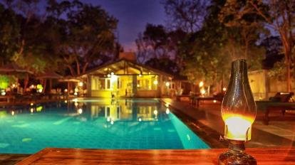 Illuminated swimming pool at Lake Lodge during the evening.