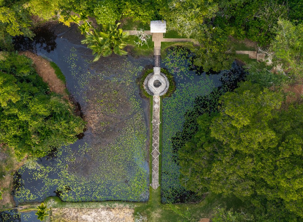 Aerial view of Lunuganga garden with ponds, pathways and a central pavilion.