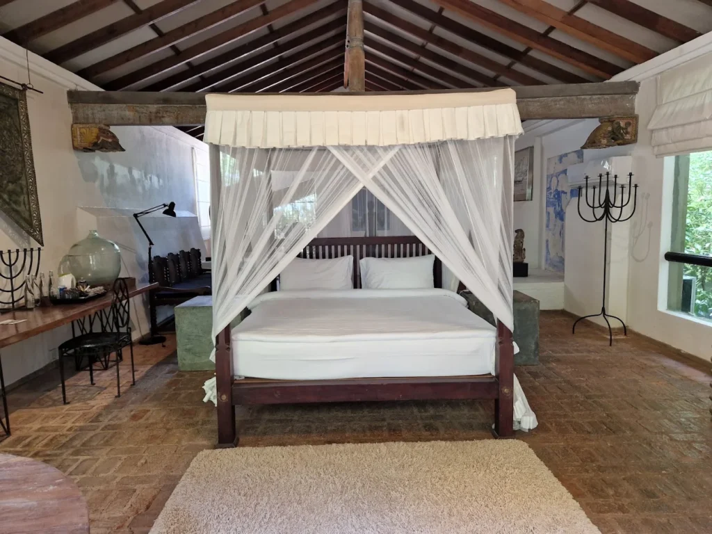 Elegant four-poster bedroom at Lunuganga Estate Hotel with heritage-style interiors.