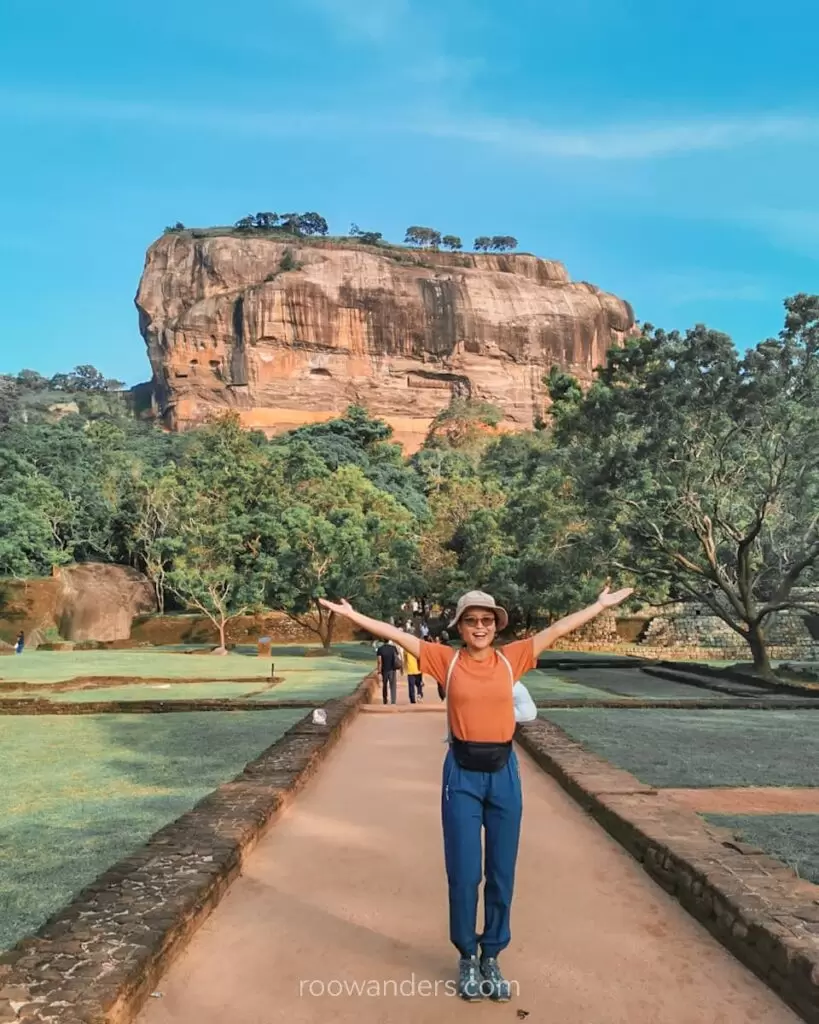 Tourist posing in front of Sigiriya Rock Fortress, Sri Lanka.