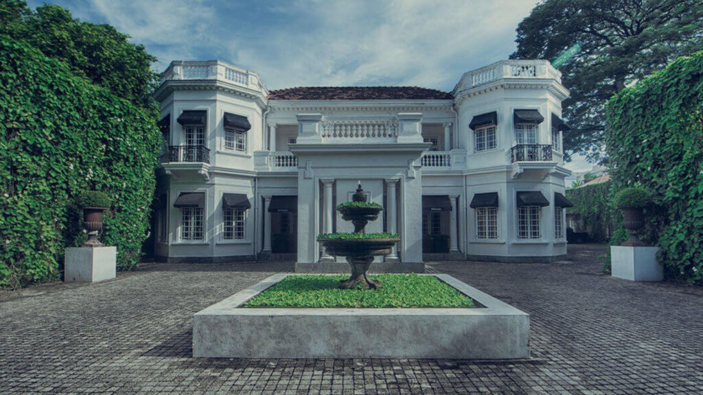 Elegant colonial mansion exterior of Tintagel Colombo surrounded by lush greenery.