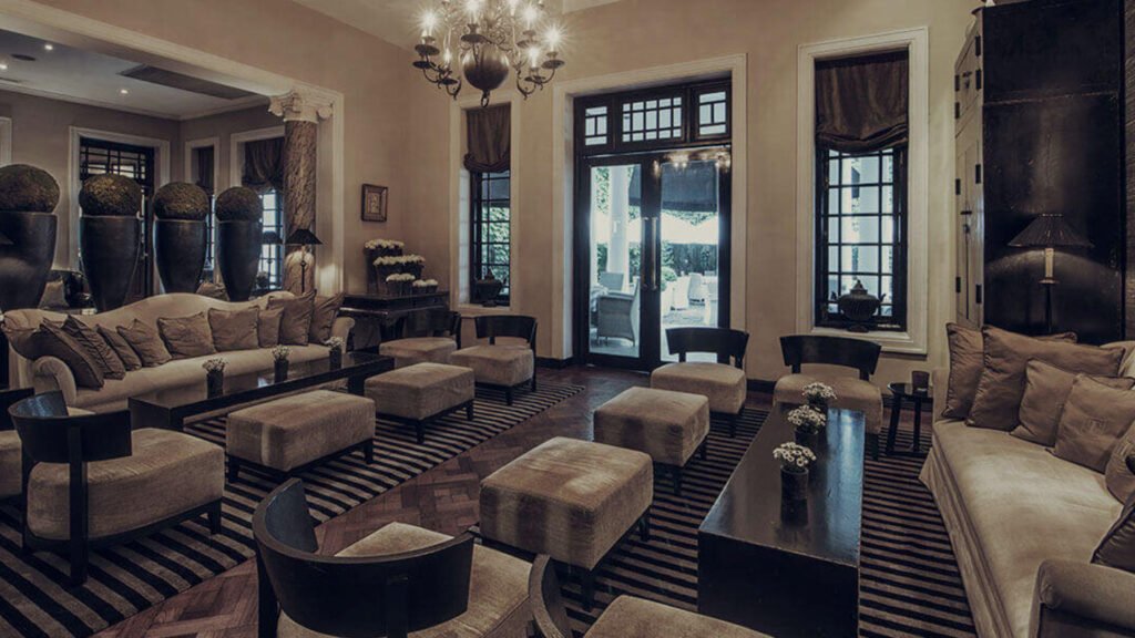 Elegant lounge interior at Tintagel Colombo with classic furnishings and chandeliers.