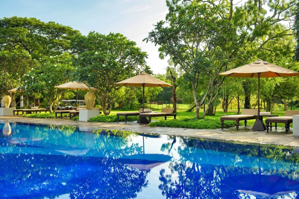 Swimming pool surrounded by lush tropical gardens at Uga Ulagalla.