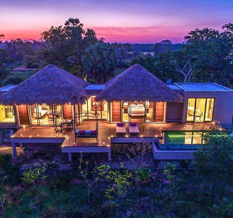 Luxury private pool villa at Uga Ulagalla surrounded by tropical greenery at sunset.