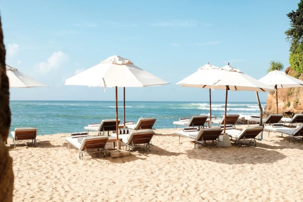 Beachfront sun loungers and parasols overlooking the Indian Ocean at Cape Weligama