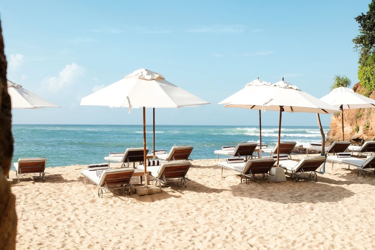 Beachfront sun loungers and parasols overlooking the Indian Ocean at Cape Weligama