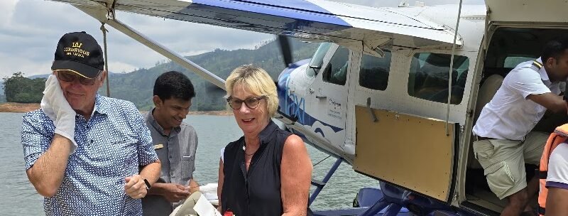 Guests welcomed with flowers after arriving by seaplane at Castlereagh Reservoir for Ceylon Tea Trails.