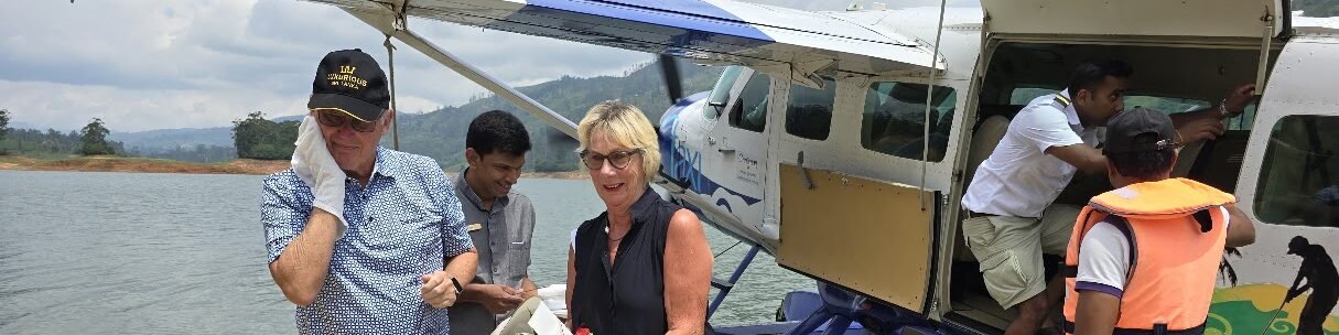 Guests welcomed with flowers after arriving by seaplane at Castlereagh Reservoir for Ceylon Tea Trails.