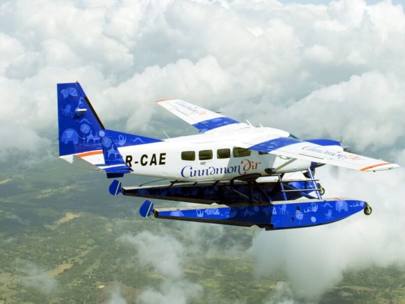 Cinnamon Air seaplane flying above Sri Lanka’s scenic hill country.
