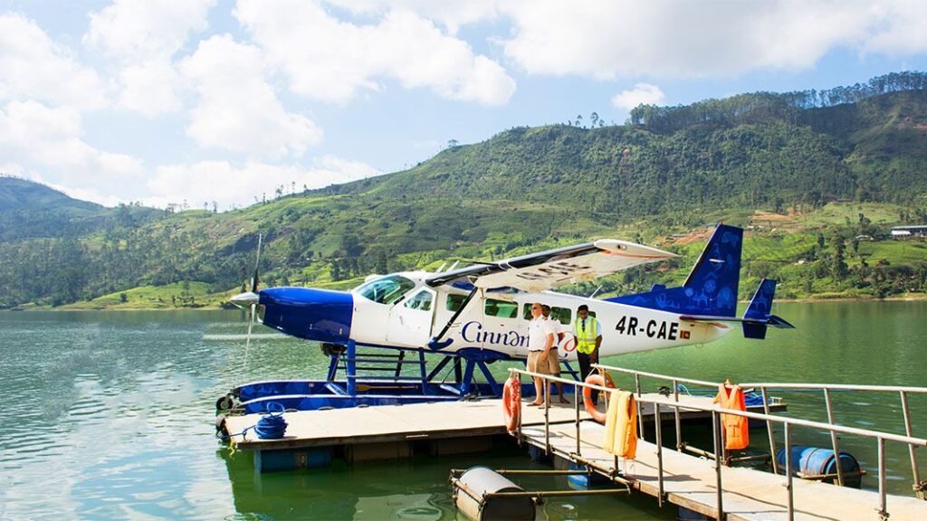 Cinnamon Air seaplane docked on a scenic lake in Sri Lanka’s hill country.