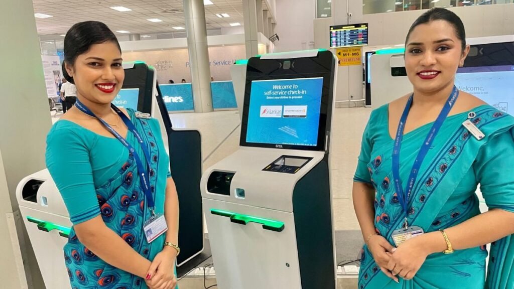 SriLankan Airlines staff assisting passengers at self-service check-in kiosks at BIA.