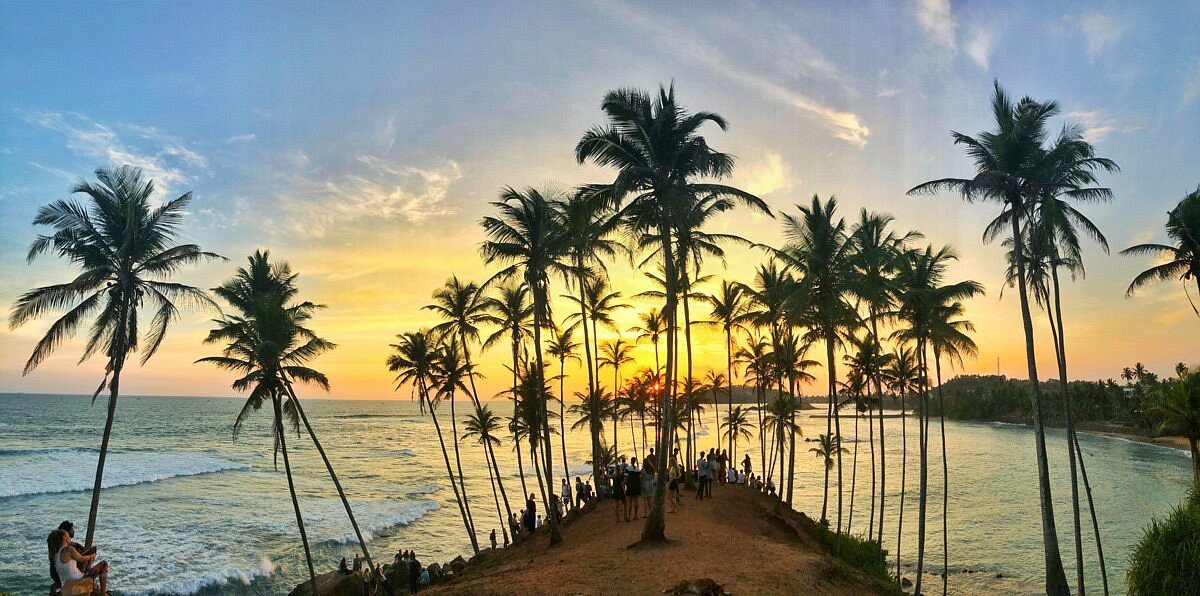 Coconut Tree Hill at sunset overlooking the Indian Ocean in Mirissa.