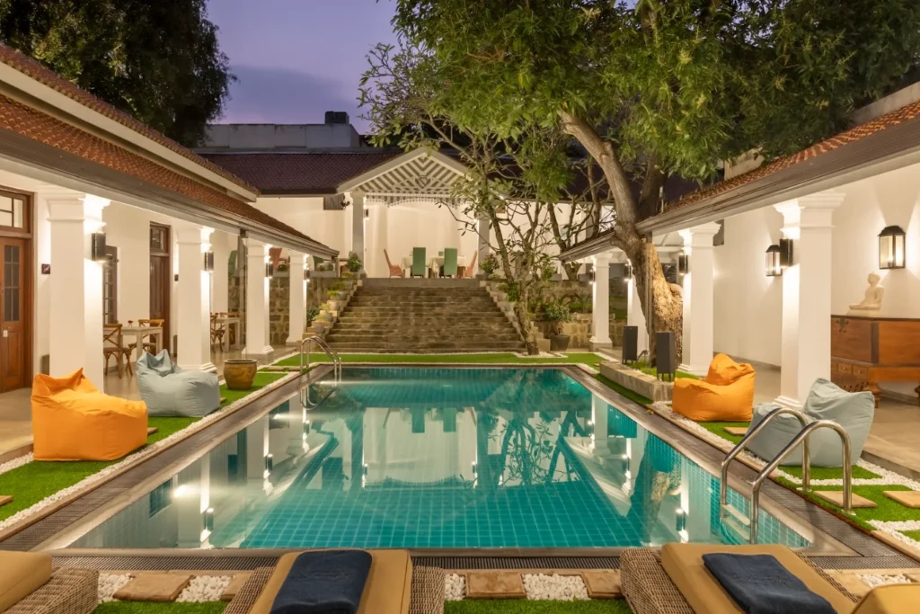 Elegant courtyard swimming pool surrounded by colonial-style architecture at La Mansion.