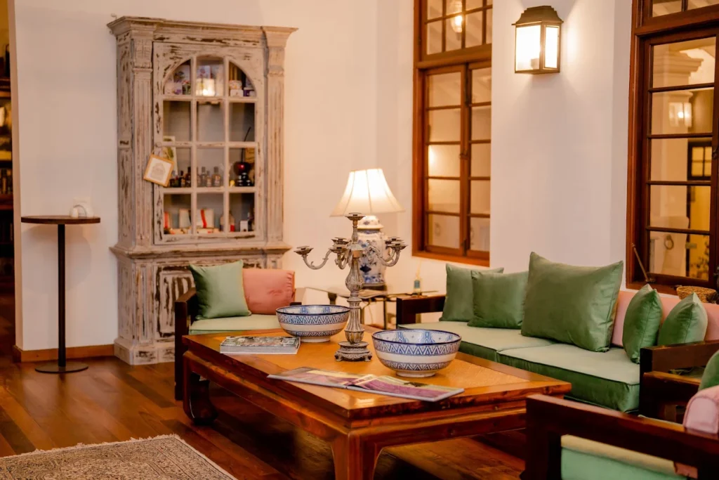 Elegant lounge interior at La Mansion with heritage furniture and warm lighting.