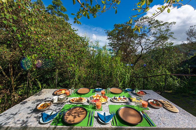 Outdoor dining surrounded by lush greenery at The Cavern Sri Lanka
